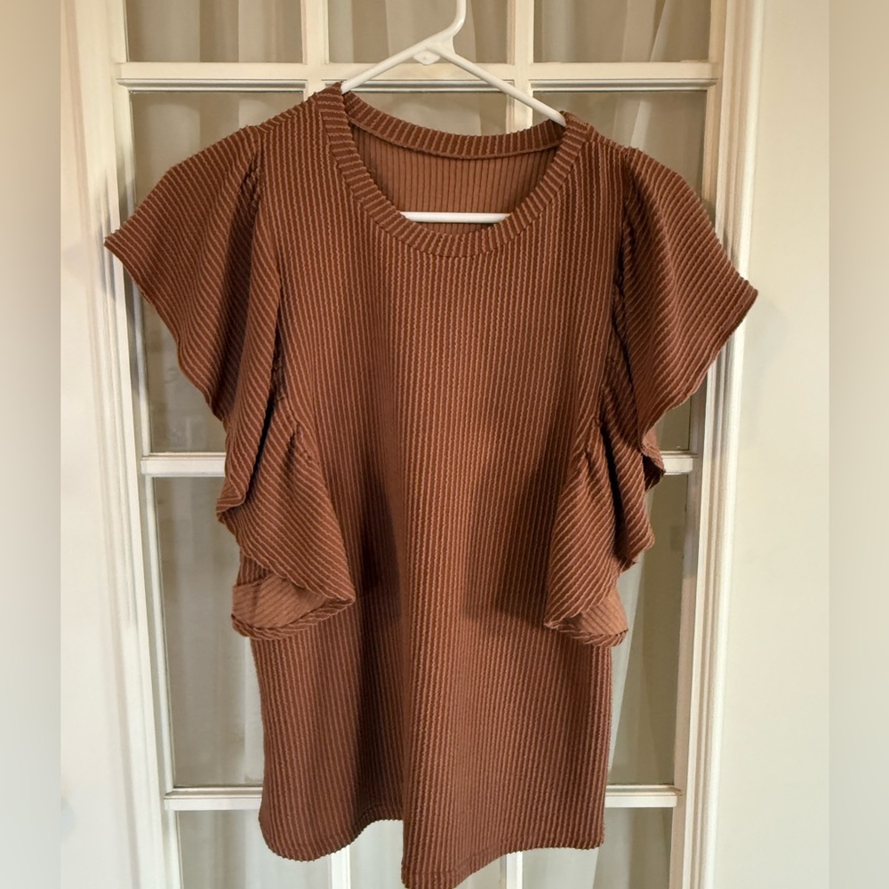 Boutique ruffle sleeve top color is brown burnt orange ish